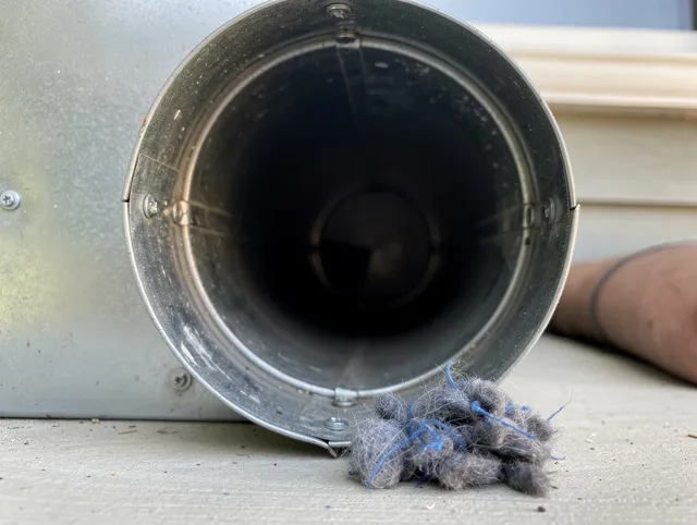 Greeley Dryer Vent Cleaning technician using specialized equipment to clear severe dryer vent blockage in Greeley